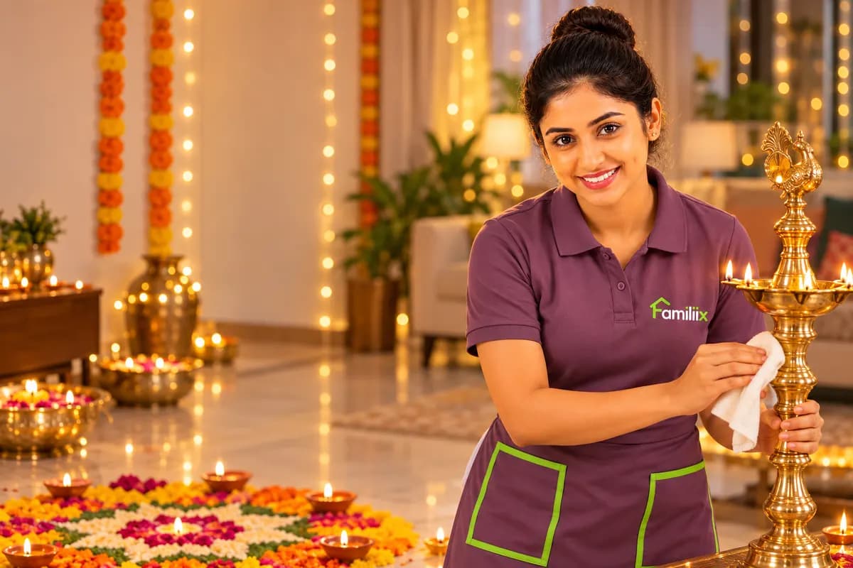 A Familiix professional in a plum uniform polishing a brass lamp in a home decorated with diyas and marigolds for Diwali